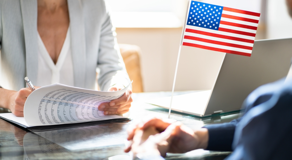 female-green-card-attorney-reviewing-paperwork-with-client